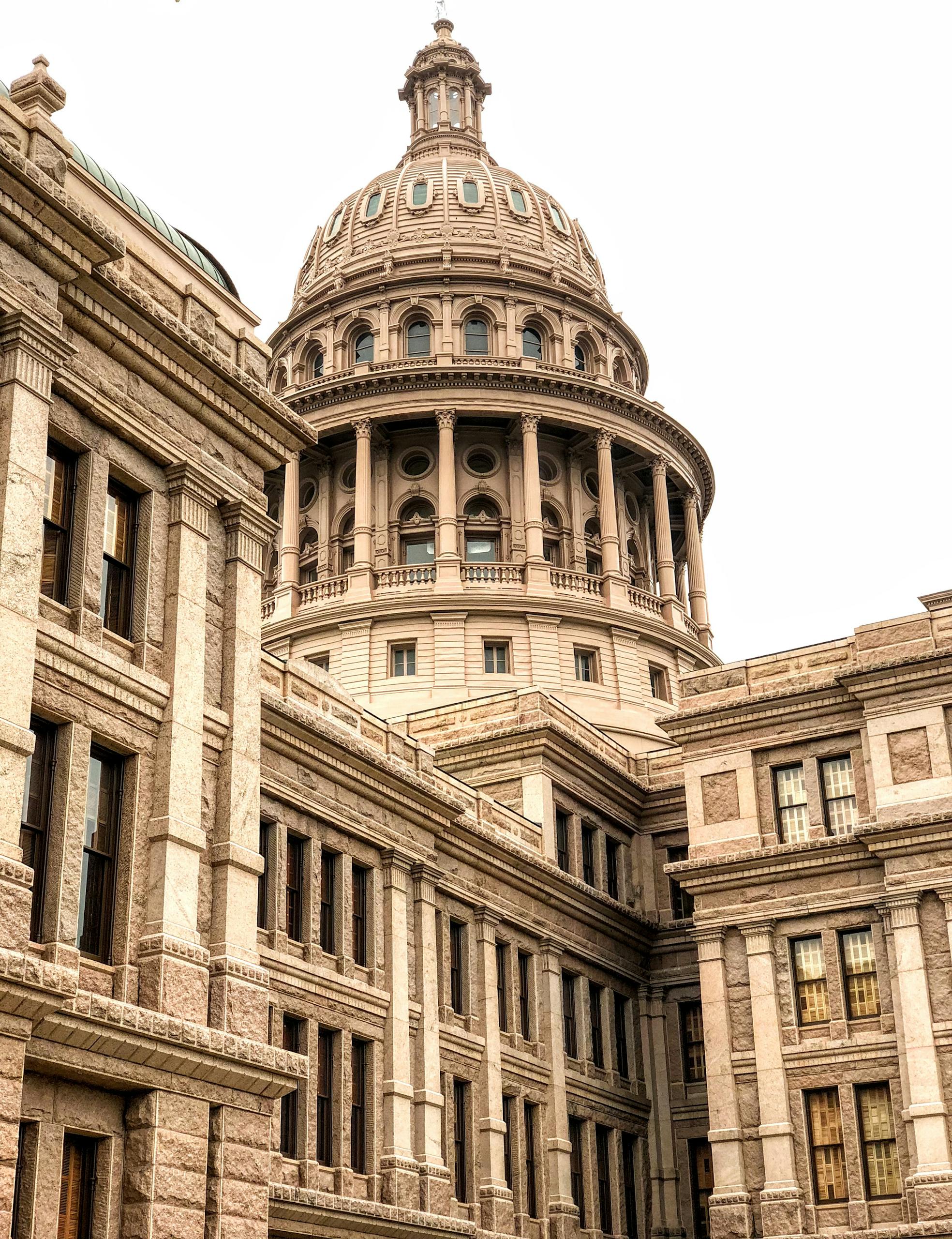 Exterior view of the Texas Capitol, showcasing its historic and architectural grandeur.