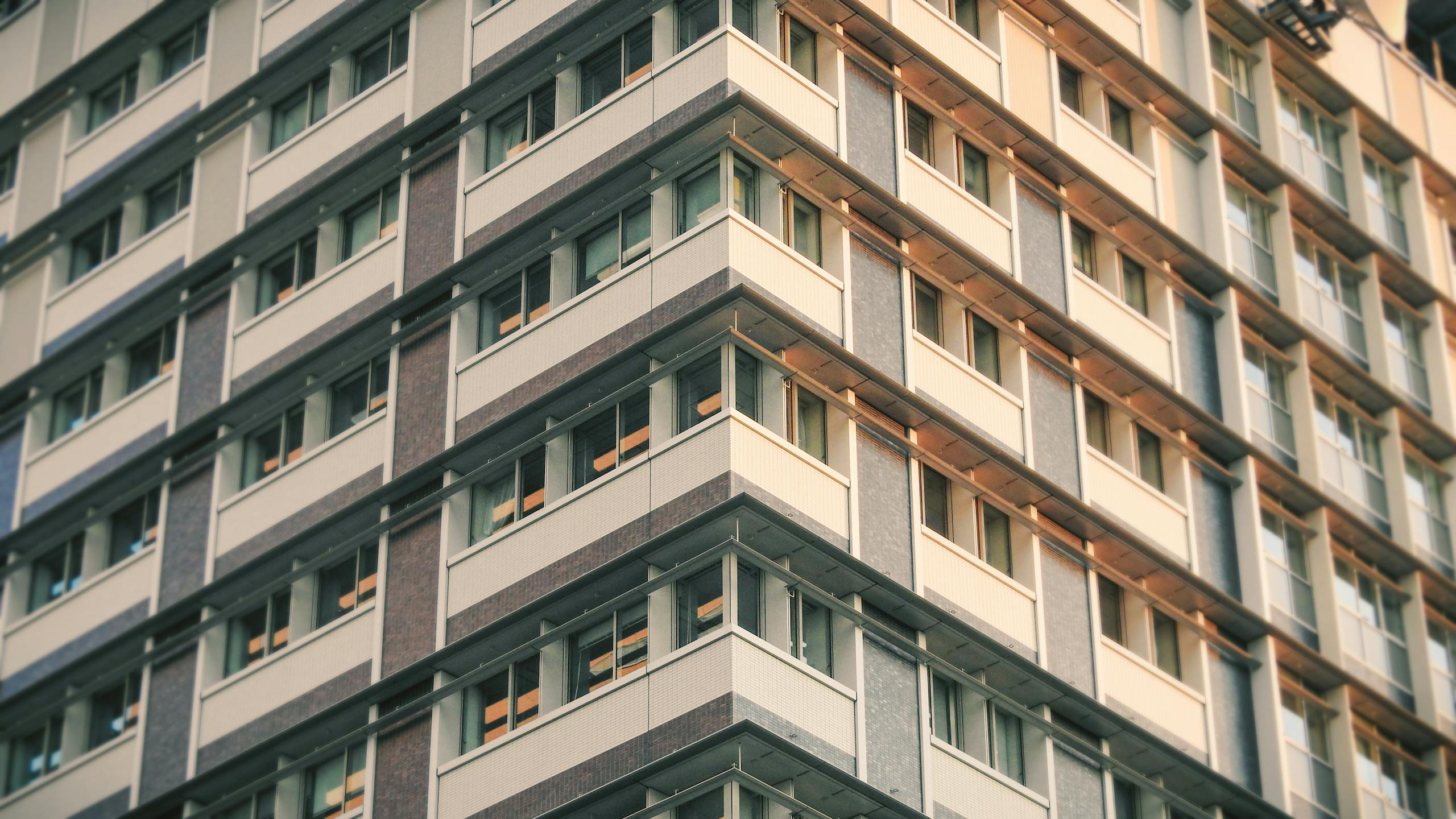 Low angle shot of a modern building showcasing architectural design in an urban setting.